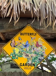 A yellow sign with butterflies on it