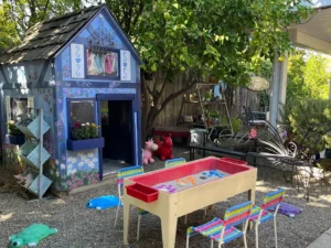 A child 's play area with a table and chairs.